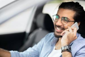 Closeup of cheerful indian man driver having phone call