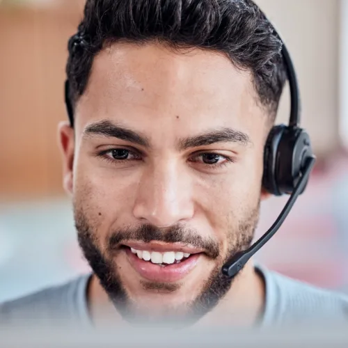 Of course we can upgrade you. Shot of a handsome young man working in a call center.