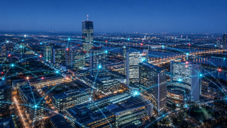 An AI-generated night-time cityscape featuring modern office buildings, a river and bridges, over which glowing data lines symbolise a confident, connected digital Vienna.